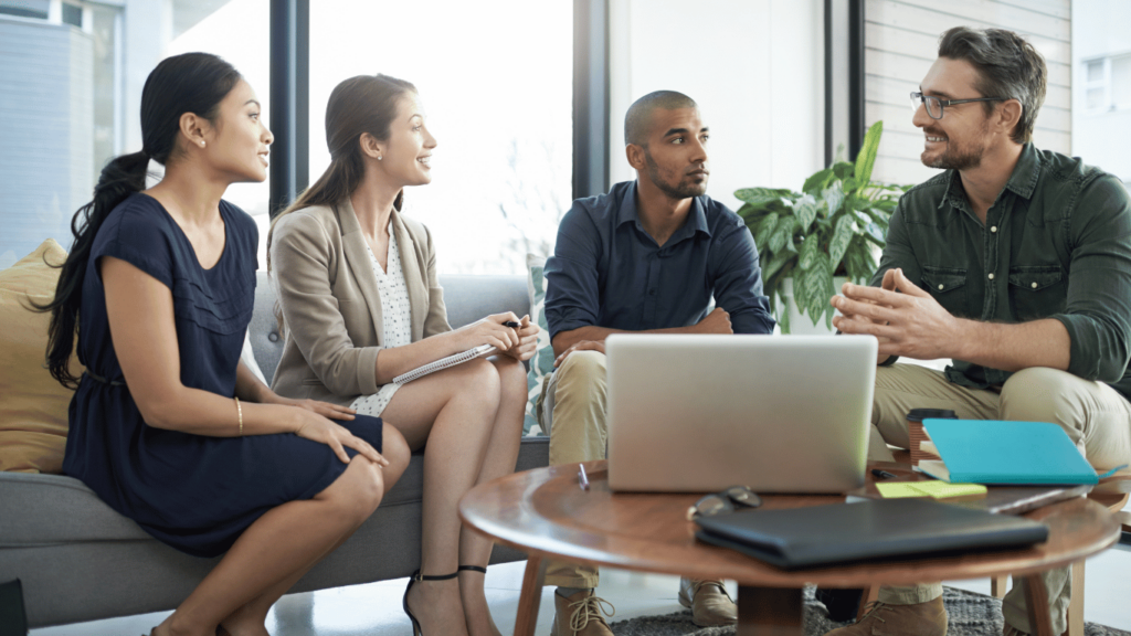 A management team discussing their options for outsourcing technical support to maximize customer satisfaction