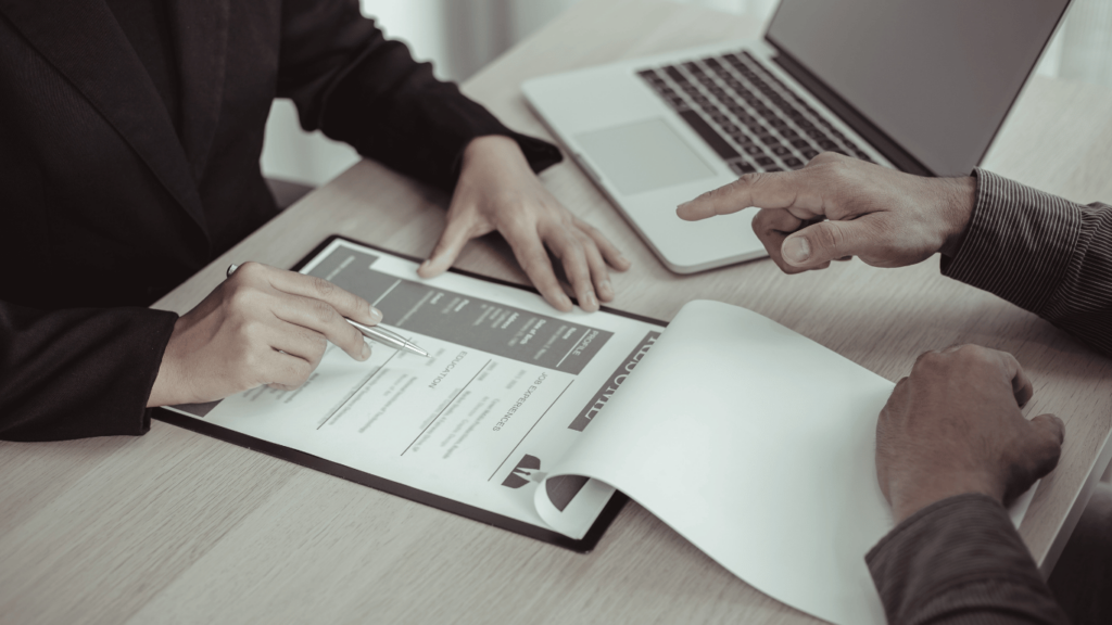 Hiring manager sifting through resumes to find the right customer service representative