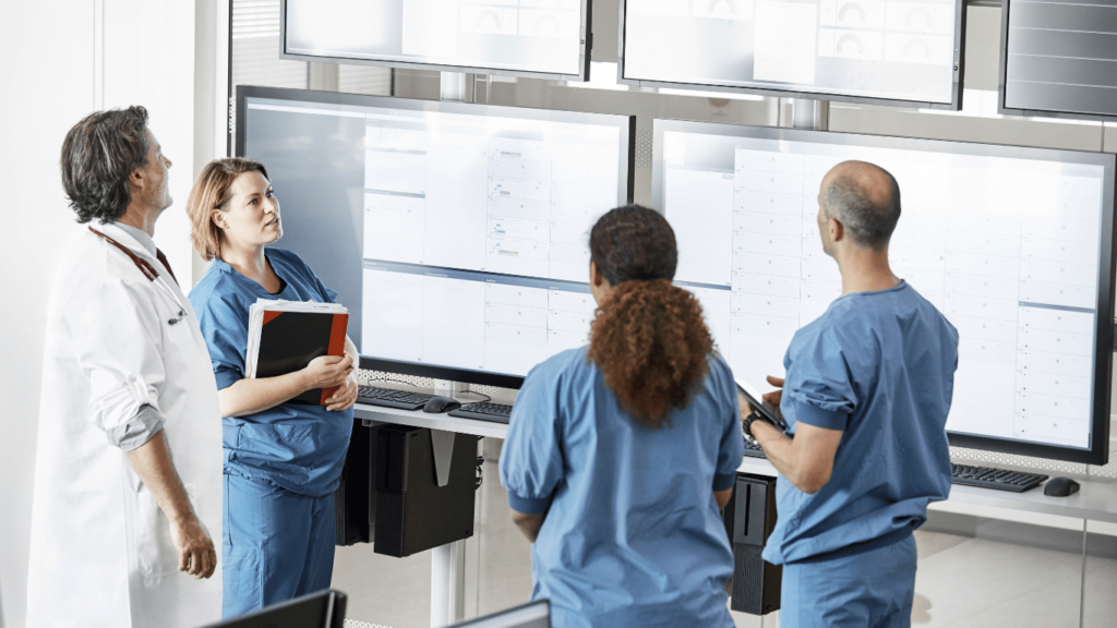 Healthcare providers from healthcare organizations conducting a meeting to discuss sensitive patient data