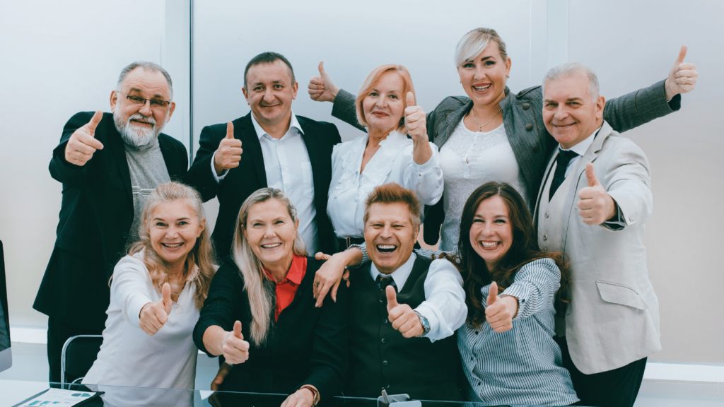 Employees showing a thumbs up
