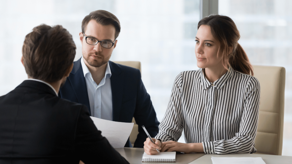 Recruitment strategy being discussed by a recruitment process outsourcing company representative and a CEO of another company
